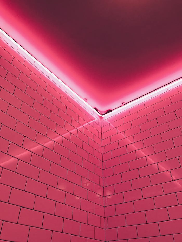 Aesthetic neon-lit pink tiled corner creating a modern and vibrant atmosphere.